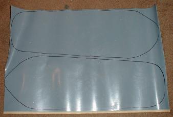 A sheet of Hypalon with two snowshoe outlines drawn on it
