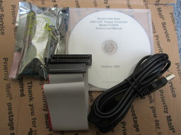 The static-wrapped FC5025 device, ribbon cable, USB cable, and software CD-ROM.