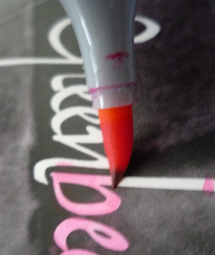 A Copic brush marker filling in the "Greenbeans" title with pink.